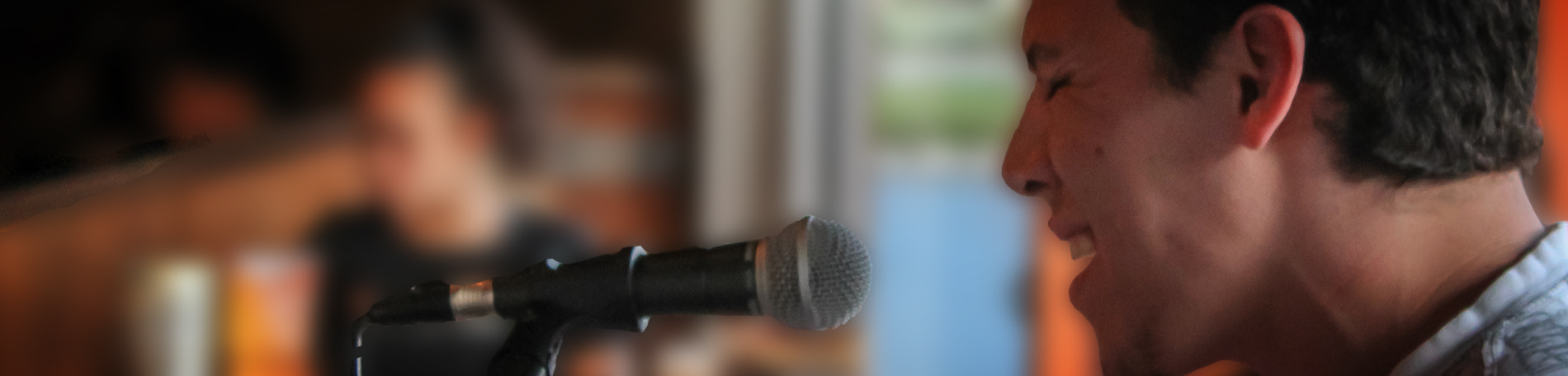 Levias performing at a microphone